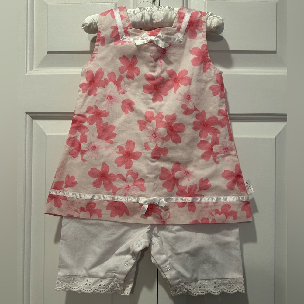 Pink Floral Baby one piece. 12-18 mos. Easy snaps on shoulders. 100% cotton. NWT